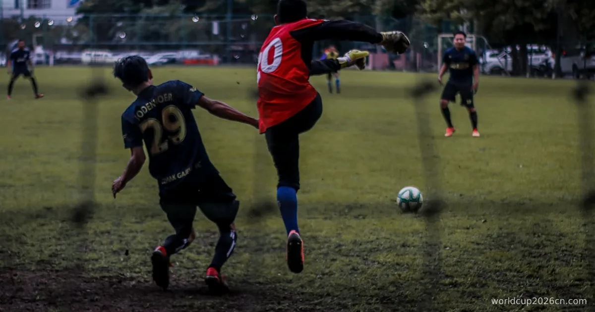 2 men playing soccer on field during daytime