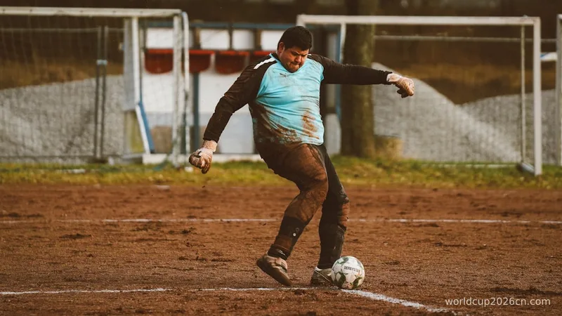 A man kicking a soccer ball across a field