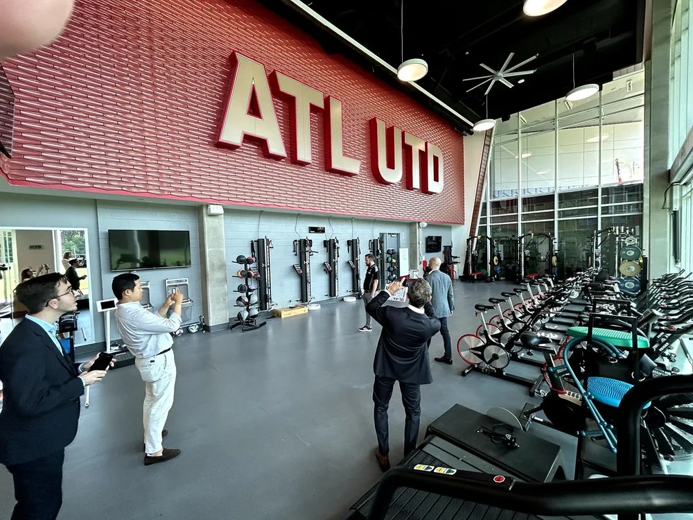 Modern national team training camp facility, outdoor training area with palm tre
